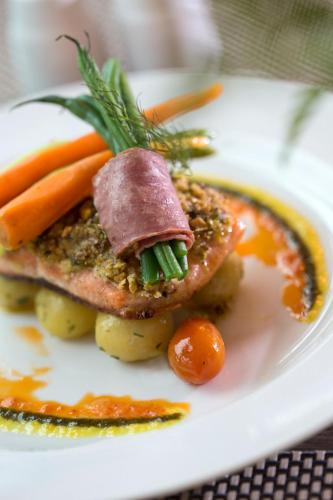a plate of food with meat and vegetables on it at Best Western Premier La Grande Bandung in Bandung