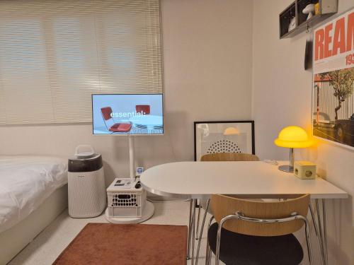 a bedroom with a bed and a table and chairs at OpenㆍJamsil Lake Stay in Seoul