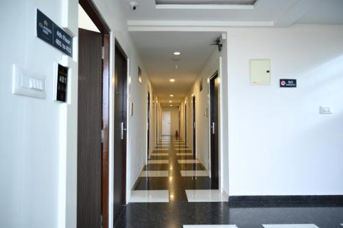 a hallway of a hospital with a long corridor at Classio inn Hotel - Near Kempegowda International Airport Bangalore Terminal 1 & 2 in Bengaluru
