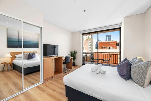 a bedroom with a large bed and a television at Perth City Retreat Victoria Ave 1br in Perth