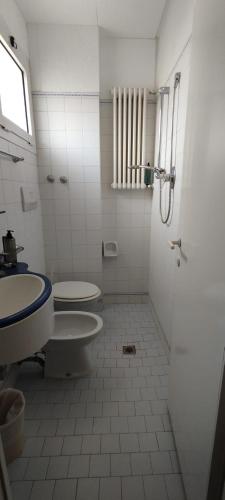 a bathroom with two toilets and a sink at Hotel Acerboli in Rimini