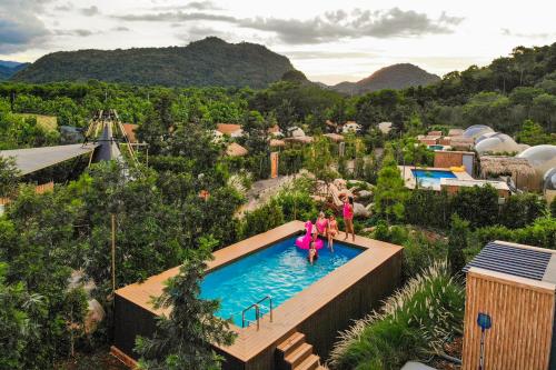 a group of people in a pool at a resort at The X10 Nordic Tent and Glamping Pool Villa Khaoyai เขาใหญ่ - SHA Certified in Ban Thung Sawang