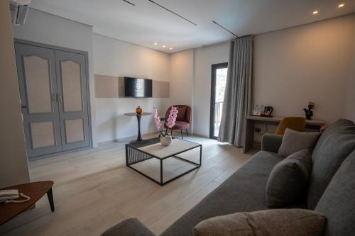 a living room with a couch and a table at Beverly Beach Hotel in Jounieh