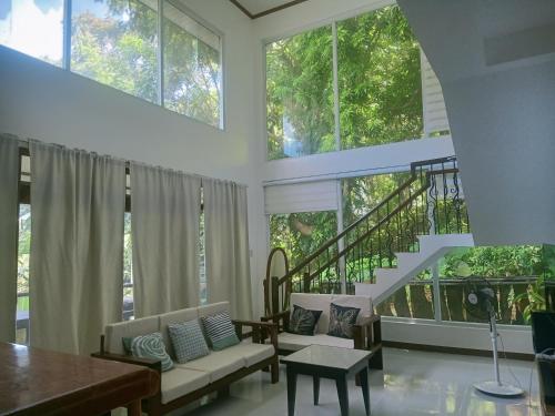 a living room with a couch and a table at Puerto Galera Hilltop Guesthouse -Tropical Retreat in Puerto Galera