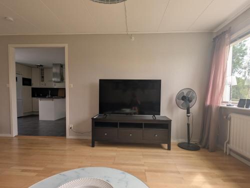 a living room with a large flat screen tv at Cozy countryside Appartment in Örebro