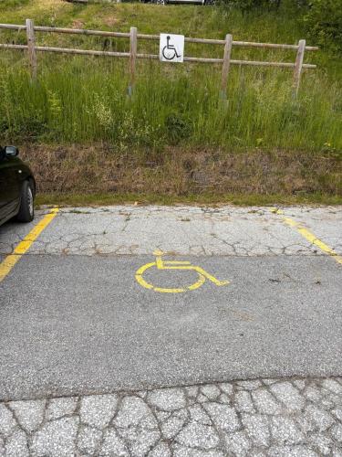 a parking lot with a wheelchair symbol on the road at Studio Cosy à proximité immédiate des télécabines in Anzère