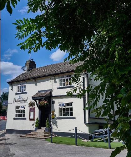 a white building with a gate in front of it at Bulls Head - Holymoorside in Chesterfield