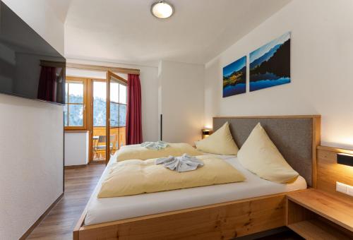a bedroom with a large bed in a room at Pension Bergbauernhof Irxner in Schladming