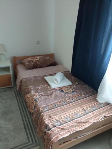 a bedroom with a bed with a laptop on it at Seosko turisticko domacinstvo Milanovic in Žuč