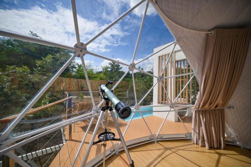 a camera on a tripod in a room with a glass ceiling at The X10 Nordic Tent and Glamping Pool Villa Khaoyai เขาใหญ่ - SHA Certified in Ban Thung Sawang