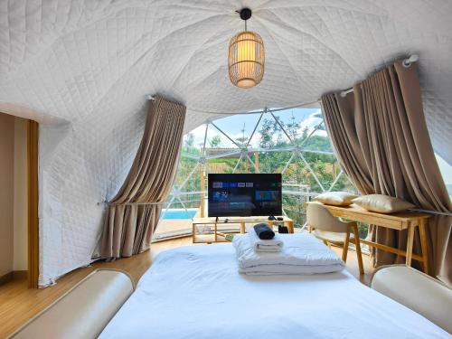a room with a bed and a large window at The X10 Nordic Tent and Glamping Pool Villa Khaoyai เขาใหญ่ - SHA Certified in Ban Thung Sawang