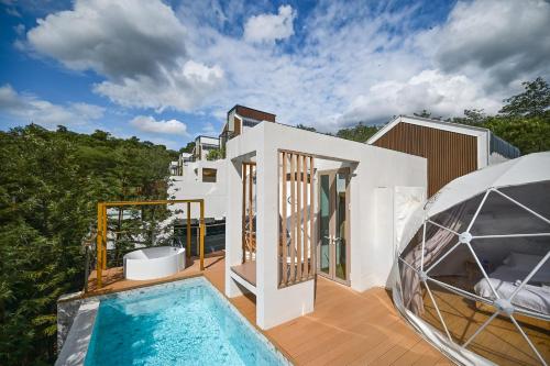 a house with a swimming pool on a deck at The X10 Nordic Tent and Glamping Pool Villa Khaoyai เขาใหญ่ - SHA Certified in Ban Thung Sawang