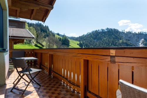 a balcony with chairs and a table and a view at Pension Bergbauernhof Irxner in Schladming