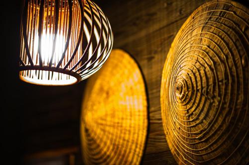 a light hanging from a wall next to a yellow object at Private Onsen 泊 - Park - Tsuetate in Oguni