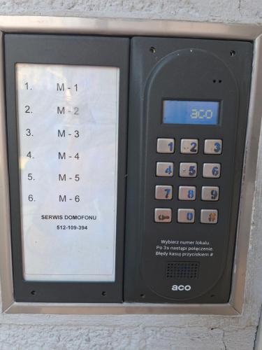 an electronic calculator is sitting on a wall at Apartament LORD in Toruń