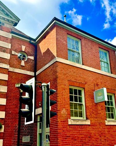 a traffic light in front of a brick building at Sleep Hotel in Worthing