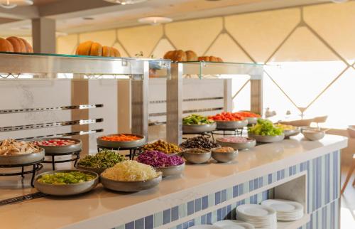 a buffet line with bowls of food on it at King Solomon Hotel Tiberias in Tiberias