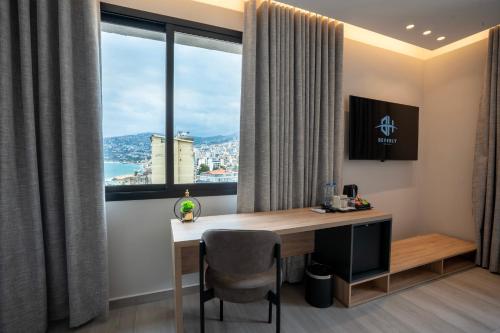 a desk in a room with a large window at Beverly Beach Hotel in Jounieh