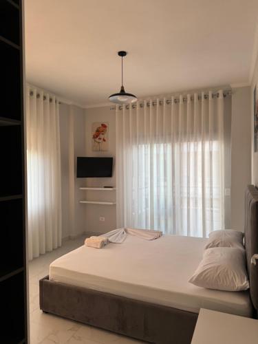 a bedroom with a large bed and a window at DG Apartment in Golem