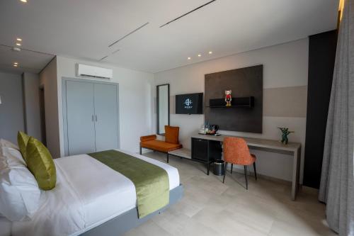 a hotel room with a bed and a desk and chairs at Beverly Beach Hotel in Jounieh