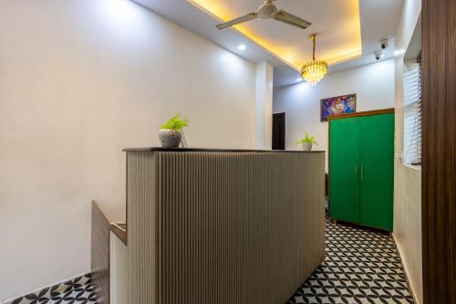 an office with a reception desk and a green door at Hotel Mannat Green Near Naraina Vihar Metro Station in New Delhi