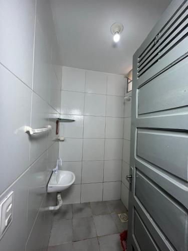 a bathroom with a sink and a toilet at Chalé 2 novo mel in Areia Branca