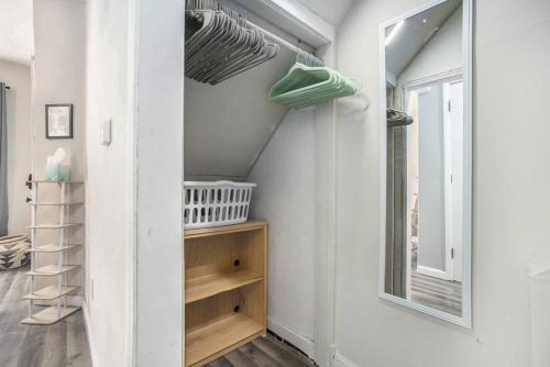 a room with white walls and a window and shelves at The Downtown Delight - New Corporate Apt Downtown in Grand Rapids