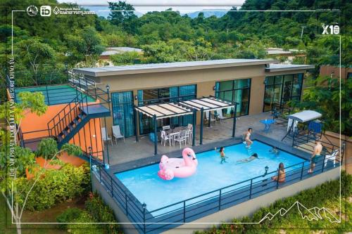 a house with a swimming pool with a pink flamingo at The X10 Nordic Tent and Glamping Pool Villa Khaoyai เขาใหญ่ - SHA Certified in Ban Thung Sawang