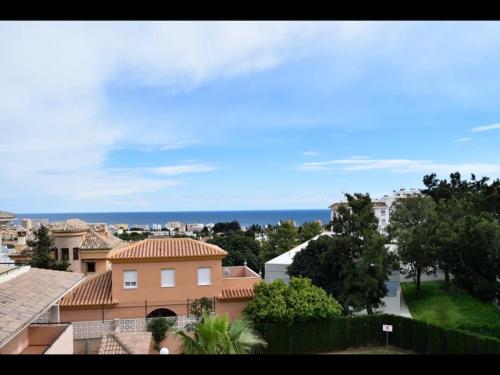 a view of a city with houses and the ocean at Penthouse with fantastic sea view in Arroyo de la Miel