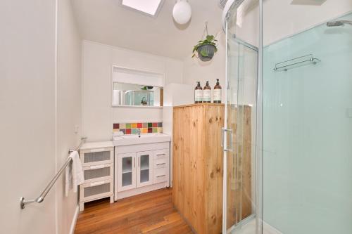 a bathroom with a shower and a glass door at Bird Rock Shack 200m to beach and pet friendly in Torquay