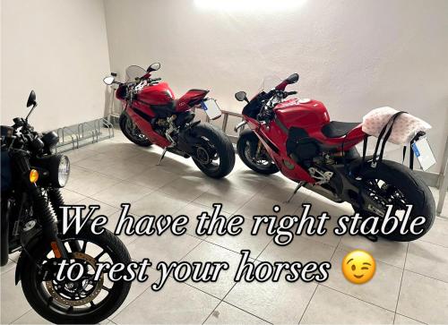 two motorcycles parked next to each other in a room at Albergo Gardesana in Torri del Benaco
