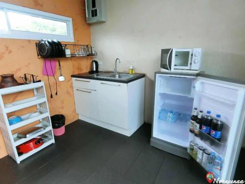 a small kitchen with a refrigerator and a microwave at The X10 Nordic Tent and Glamping Pool Villa Khaoyai เขาใหญ่ - SHA Certified in Ban Thung Sawang