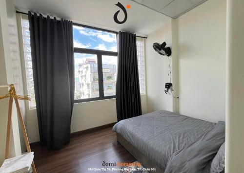 Ένα ή περισσότερα κρεβάτια σε δωμάτιο στο DeMi Homestay 2 - Châu Đốc