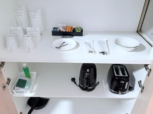 a white shelf with a black appliance on it at Tropicana Motor Inn in Cowes