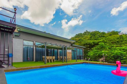 a swimming pool in front of a house at The X10 Nordic Tent and Glamping Pool Villa Khaoyai เขาใหญ่ - SHA Certified in Ban Thung Sawang