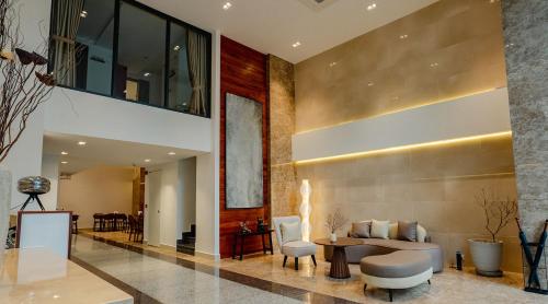 a lobby with a couch and a table and chairs at The Scenic Hotel in Phnom Penh