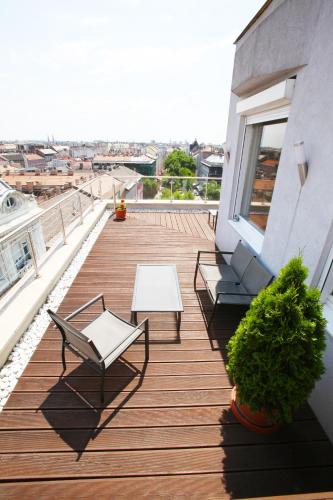 a balcony with two chairs and a table on a building at Medos Hotel in Budapest