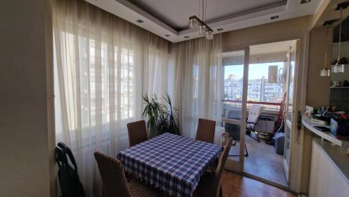 a table and chairs in a room with a window at Sava Centar in Novi Beograd