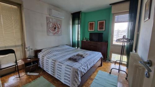 a bedroom with a bed and a green wall at Sava Centar in Novi Beograd