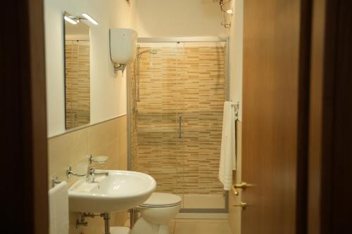 a bathroom with a sink and a toilet and a shower at Sergio apartments - Vaiano in Valiano