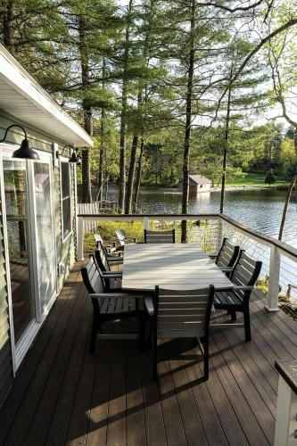a wooden deck with a table and chairs on it at Tri-Lake Escape in Naples