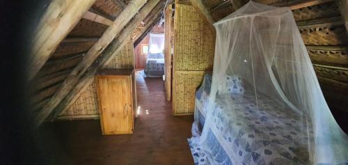 a bedroom with a bed with a mosquito net at Viva O Sonho 