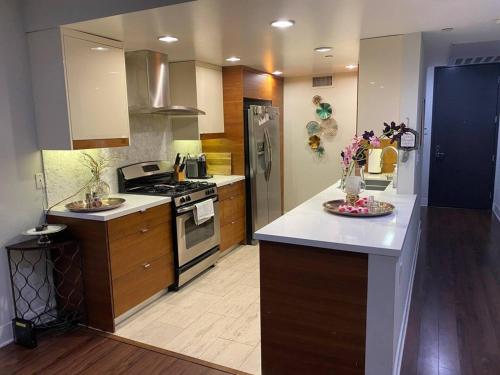 a kitchen with wooden cabinets and a stove top oven at Glendale Americana 2 Bedroom 2 Bathroom Condo in Glendale