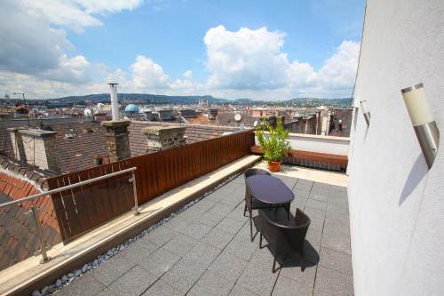 a balcony with a chair and a view of a city at Medos Hotel in Budapest