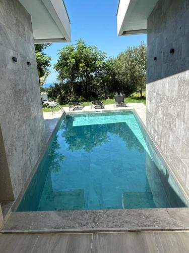 a swimming pool in a house at Hilltop Villa in Shetaj
