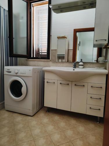 a bathroom with a washing machine and a sink at Holiday in Paradise in Balestrate