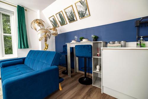 a blue living room with a blue couch and a counter at Modern 2-Bed Apartment - Near Train and Town - Parking Available in High Wycombe