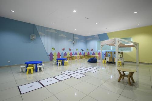 a classroom with tables and chairs and a tiled floor at Sunset View Stay at Conezion IOI in Gua Sai