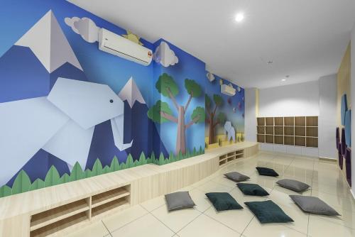 a room with a mural of mountains and trees at Sunset View Stay at Conezion IOI in Gua Sai