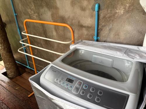 a microwave sitting on top of a counter at Wooden House,Rustic charm in quiet area in Ban Khlong Chi Lat